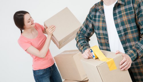 Trained movers using proper lifting technique during a relocation
