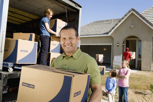 Worker securing items inside a moving van